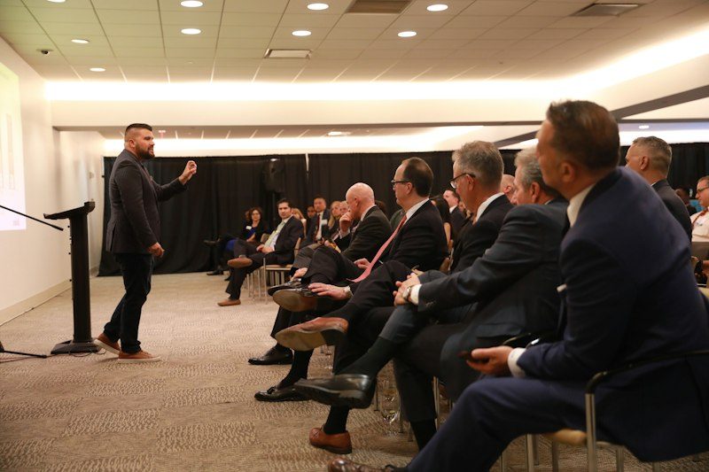Executive team presenting in high-tech modern boardroom
