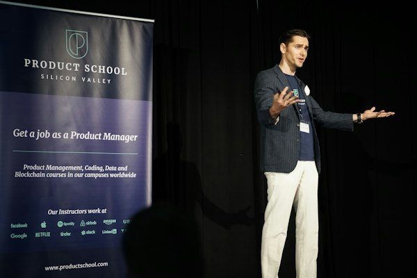 Man standing on stage speaking with poise